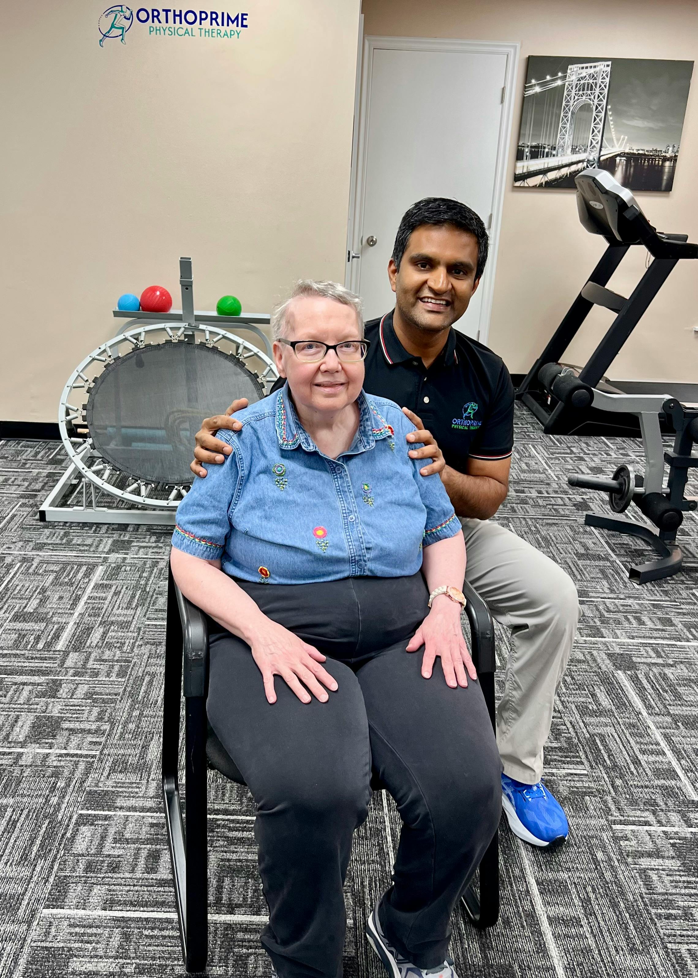 Dr. Upen Vyas, PT, DPT, OMPT, OCS behind older woman sitting in a chair